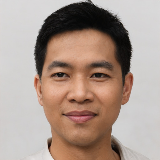 Joyful asian young-adult male with short  black hair and brown eyes