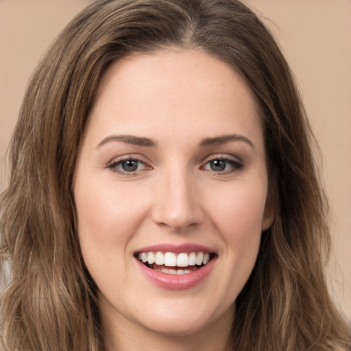 Joyful white young-adult female with long  brown hair and brown eyes