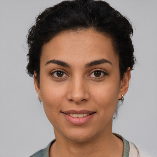 Joyful latino young-adult female with short  brown hair and brown eyes