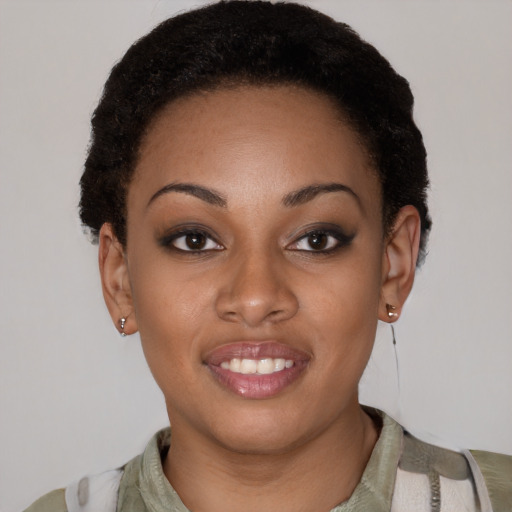Joyful black young-adult female with short  black hair and brown eyes