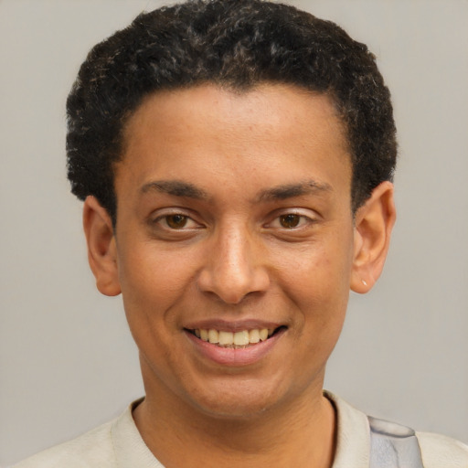 Joyful latino young-adult male with short  brown hair and brown eyes