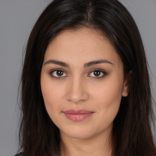 Joyful white young-adult female with long  brown hair and brown eyes