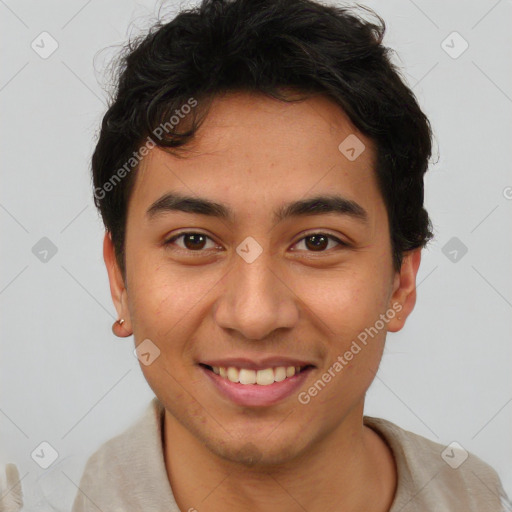 Joyful latino young-adult male with short  brown hair and brown eyes