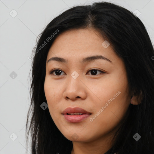 Joyful asian young-adult female with long  black hair and brown eyes