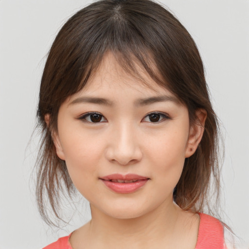 Joyful asian child female with medium  brown hair and brown eyes