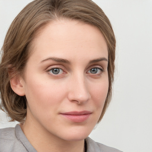 Joyful white young-adult female with medium  brown hair and blue eyes