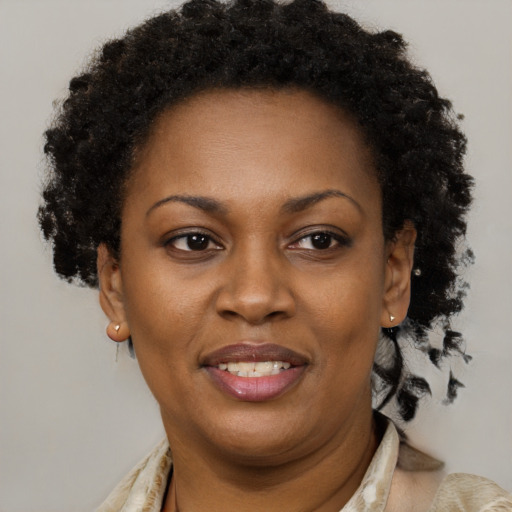 Joyful black adult female with short  brown hair and brown eyes