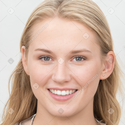 Joyful white young-adult female with long  brown hair and blue eyes