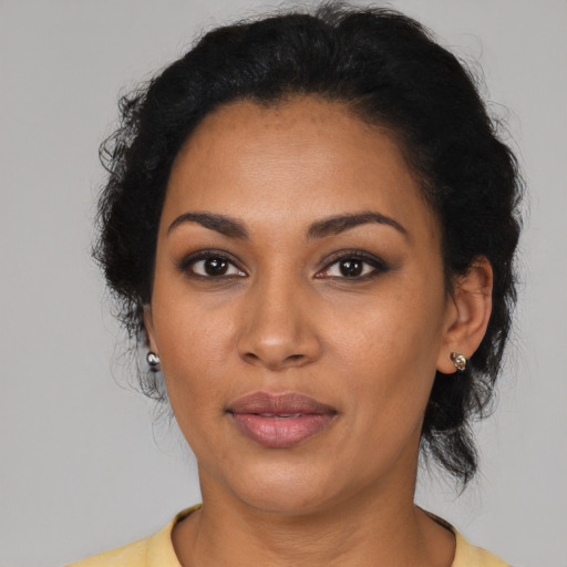 Joyful latino young-adult female with short  black hair and brown eyes