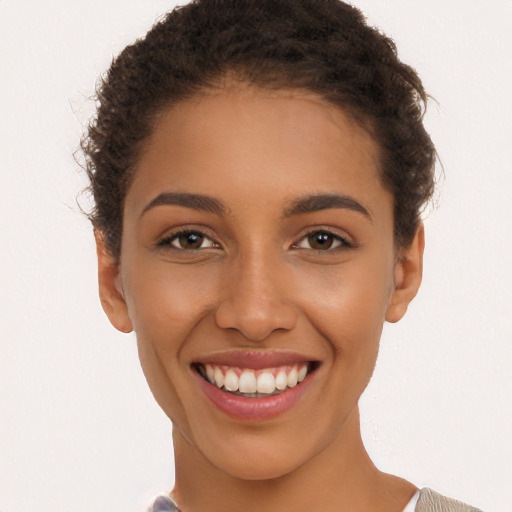 Joyful latino young-adult female with short  brown hair and brown eyes