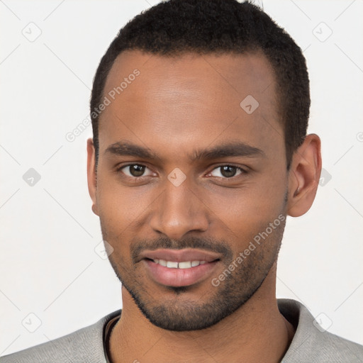 Joyful black young-adult male with short  brown hair and brown eyes