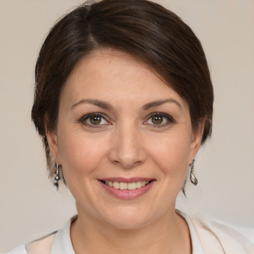 Joyful white adult female with medium  brown hair and brown eyes