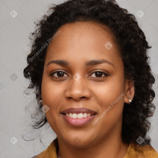 Joyful black young-adult female with long  brown hair and brown eyes