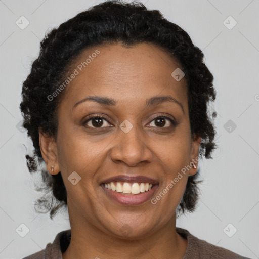 Joyful black adult female with short  brown hair and brown eyes