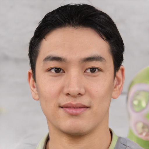 Joyful asian young-adult male with short  black hair and brown eyes