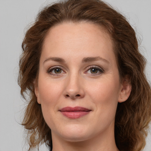 Joyful white young-adult female with long  brown hair and green eyes