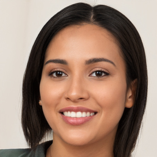 Joyful white young-adult female with long  black hair and brown eyes