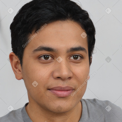 Joyful latino young-adult male with short  brown hair and brown eyes