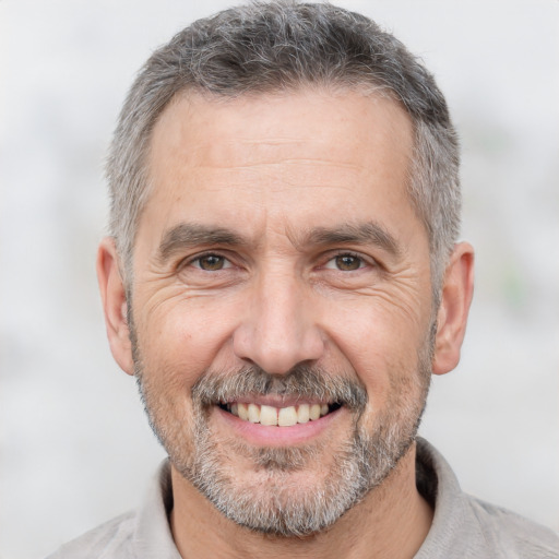 Joyful white middle-aged male with short  gray hair and brown eyes