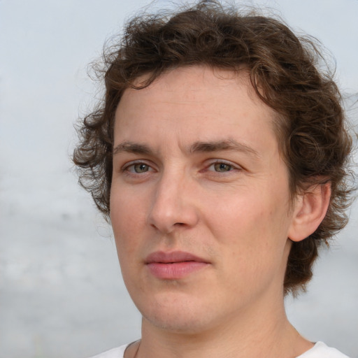 Joyful white young-adult male with medium  brown hair and brown eyes