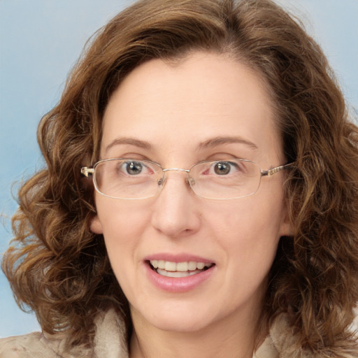 Joyful white adult female with medium  brown hair and green eyes