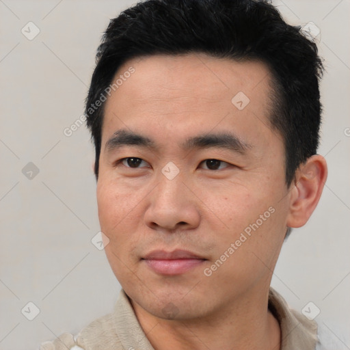 Joyful asian young-adult male with short  black hair and brown eyes