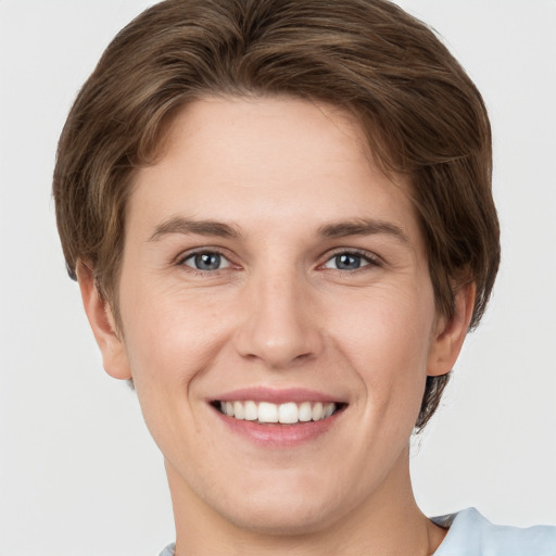 Joyful white young-adult female with short  brown hair and grey eyes