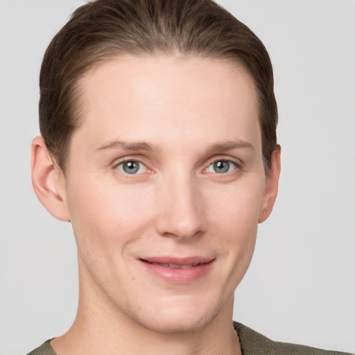 Joyful white young-adult female with short  brown hair and grey eyes