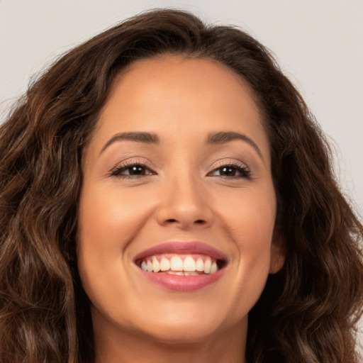 Joyful white young-adult female with long  brown hair and brown eyes