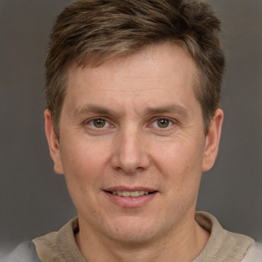 Joyful white adult male with short  brown hair and grey eyes