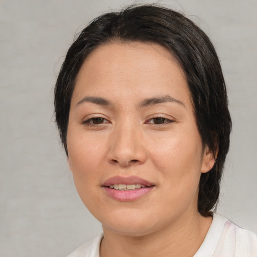 Joyful asian young-adult female with medium  brown hair and brown eyes