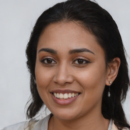 Joyful latino young-adult female with medium  brown hair and brown eyes