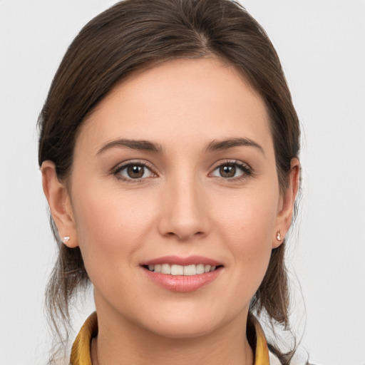 Joyful white young-adult female with medium  brown hair and grey eyes