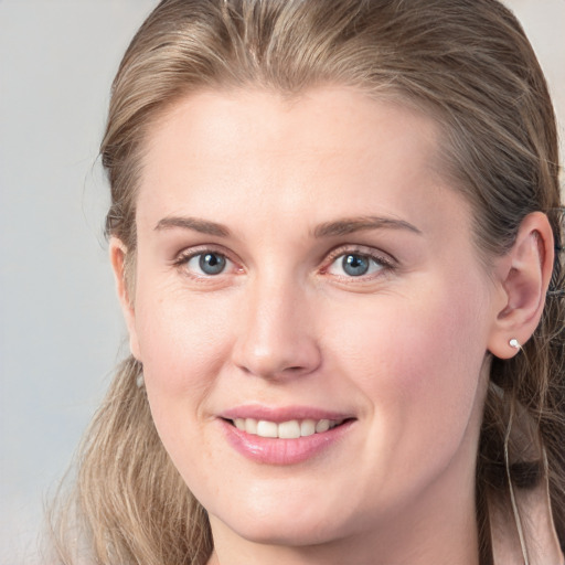 Joyful white young-adult female with long  brown hair and grey eyes