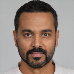 Neutral latino young-adult male with short  black hair and brown eyes