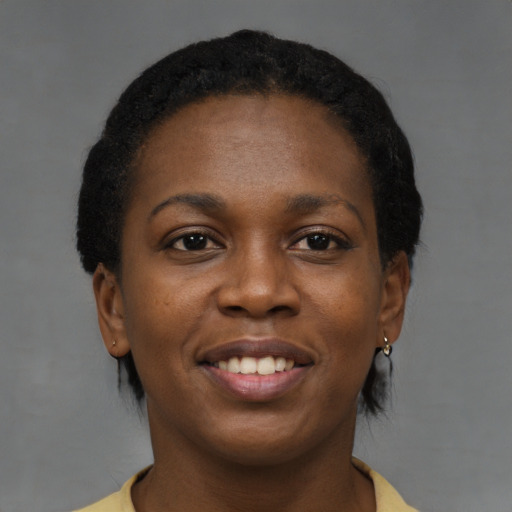 Joyful black young-adult female with short  brown hair and brown eyes