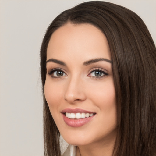 Joyful white young-adult female with long  black hair and brown eyes