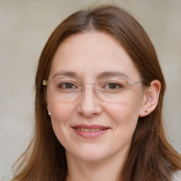 Joyful white adult female with long  brown hair and brown eyes