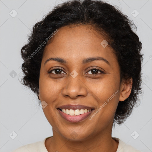 Joyful black young-adult female with long  brown hair and brown eyes