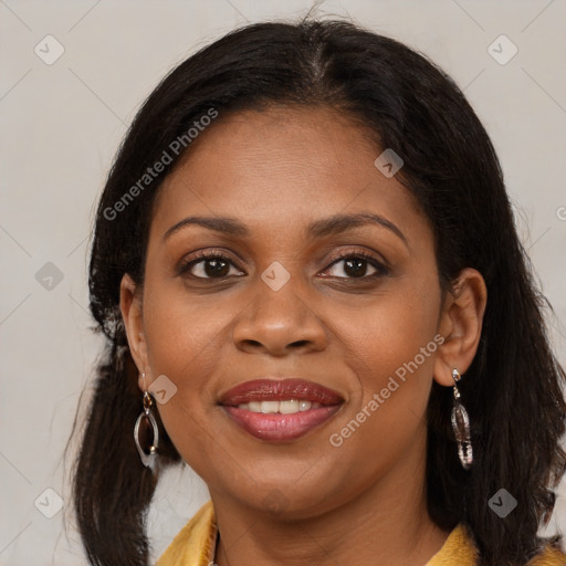 Joyful black young-adult female with long  brown hair and brown eyes