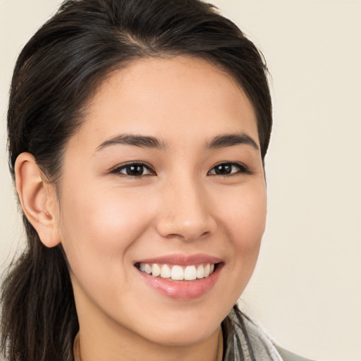 Joyful white young-adult female with long  brown hair and brown eyes