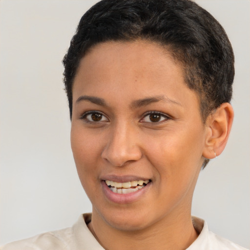 Joyful latino young-adult female with short  brown hair and brown eyes