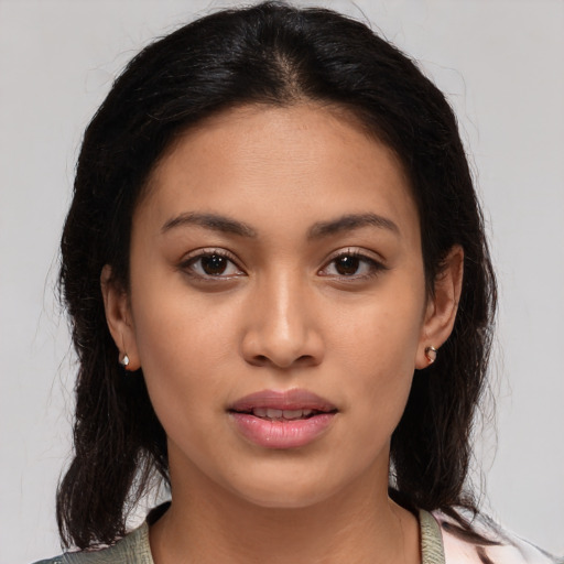 Joyful latino young-adult female with medium  brown hair and brown eyes