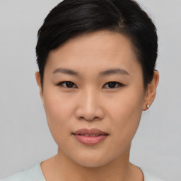 Joyful asian young-adult female with short  brown hair and brown eyes