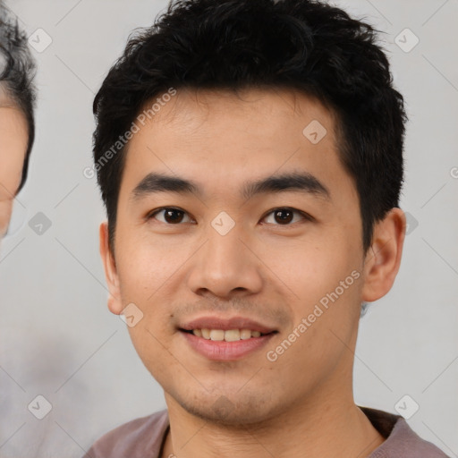 Joyful asian young-adult male with short  black hair and brown eyes