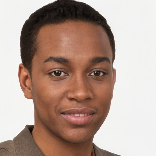 Joyful black young-adult male with short  brown hair and brown eyes