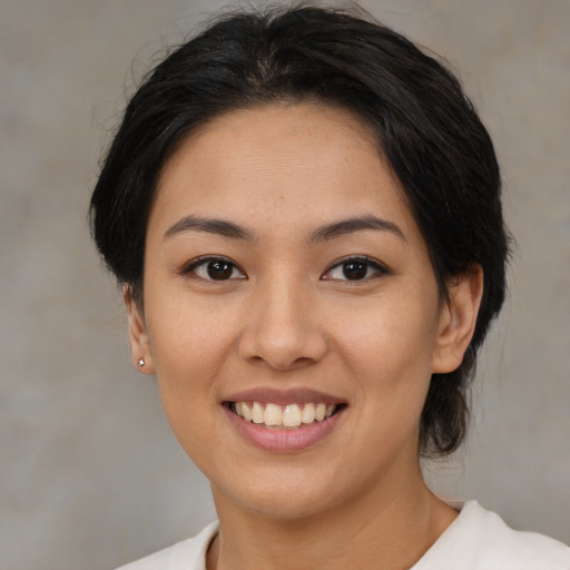 Joyful asian young-adult female with medium  black hair and brown eyes