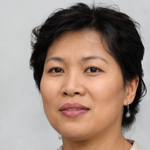 Joyful asian adult female with medium  brown hair and brown eyes