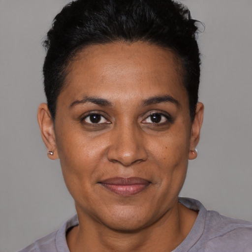 Joyful black adult female with short  black hair and brown eyes