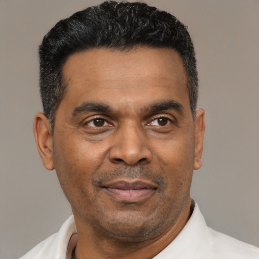 Joyful latino adult male with short  black hair and brown eyes